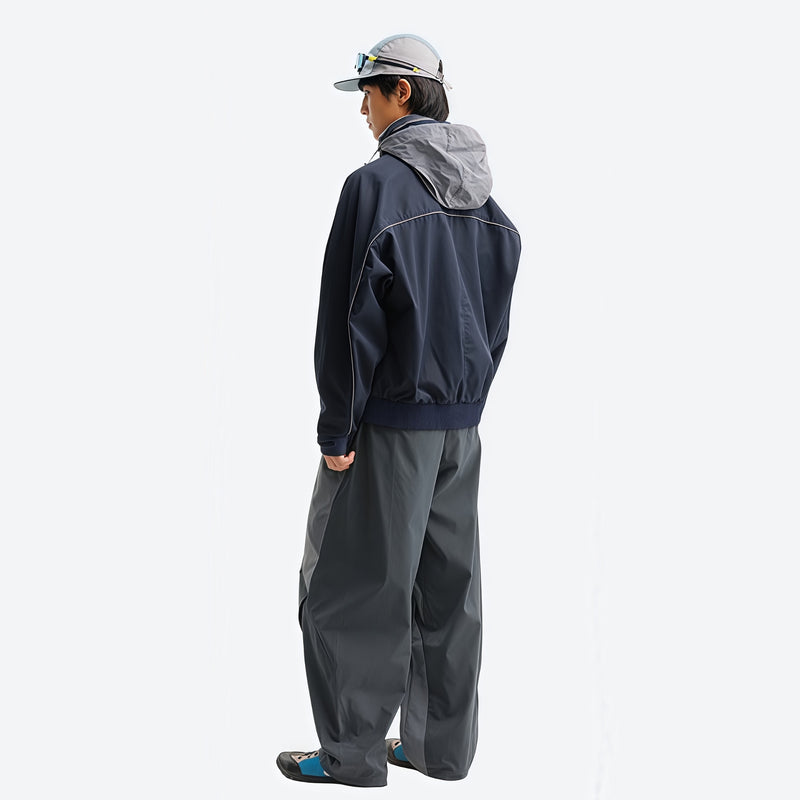 Unisex lightweight softshell outdoor pants - navy softshell jacket with gray pants, on-model side view, for hiking and travel