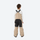 Kids breathable snowboard jacket and bib pants set - tan bib pants with black knee patches, kids on-model back view