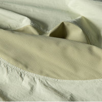 
                  
                    Packable hooded sun jacket for outdoor - cream yellow sun jacket, fabric wrinkle close-up, for travel and city walks
                  
                