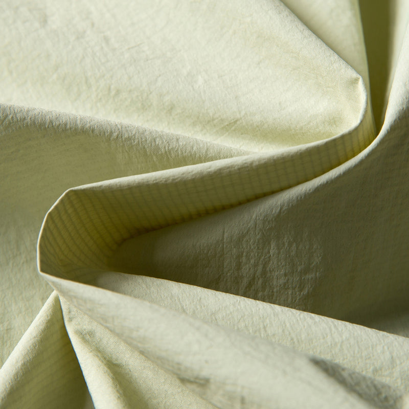 Lightweight water-repellent sun protection jacket - cream yellow sun jacket, fabric close-up, for cycling and commuting