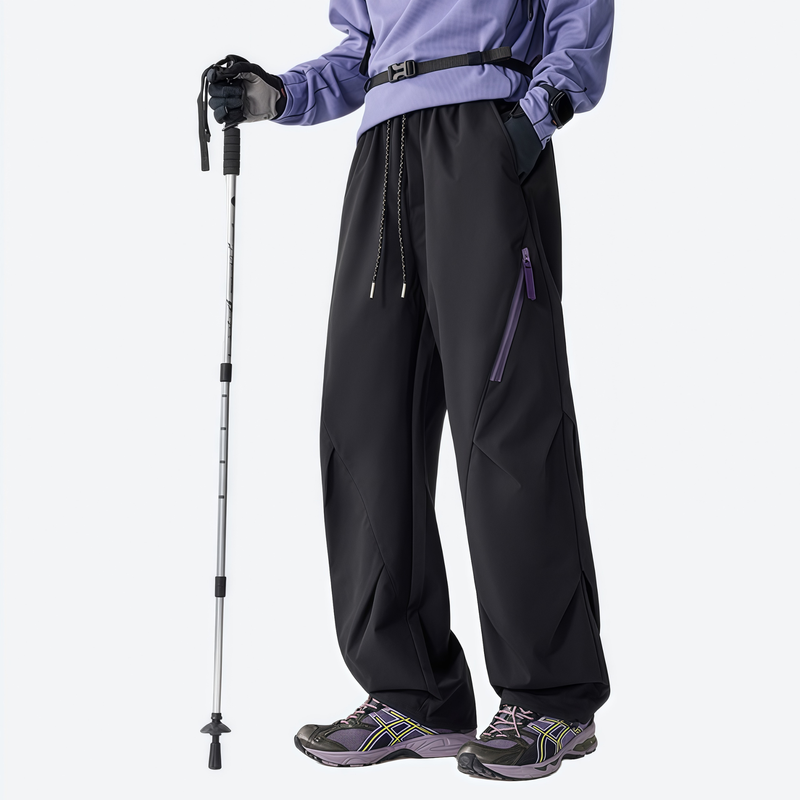 Unisex waterproof 2-in-1 down pants with liner - black down pants, front view with poles, for cold-weather winter sports