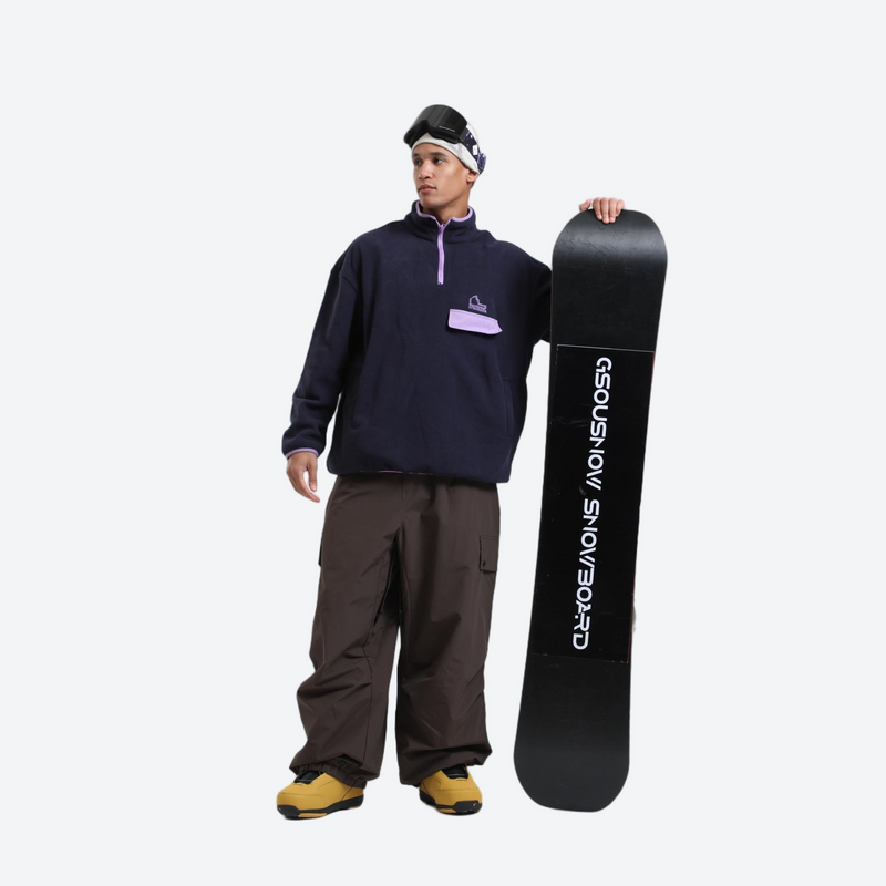 3-layer snowboard cargo pants - coffee brown snow pants, on-model front with upright snowboard, for resort and street wear