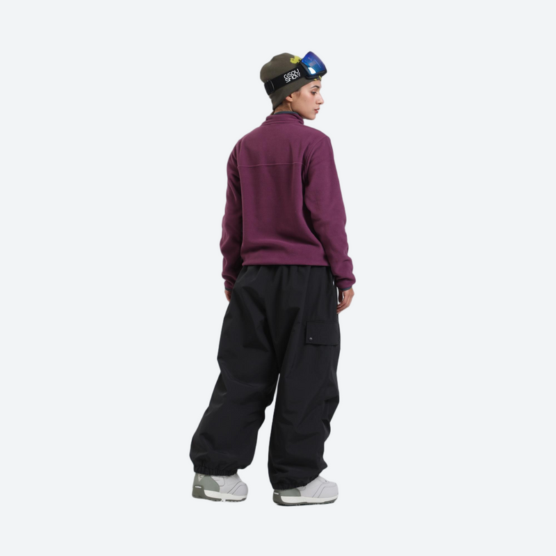 Waterproof 3L cargo snow pants - black snow pants with purple pullover, on-model side view, for resort and street wear
