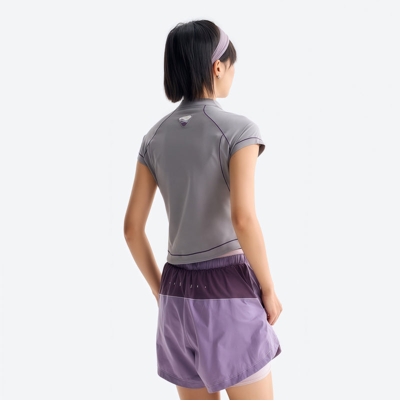 Women's stretchy fitted tee for outdoor - light gray half-zip short sleeve tee on women, back standing view