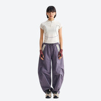 
                  
                    Lightweight water-repellent hiking pants with pockets - mauve purple quick-dry hiking pants with white tee
                  
                