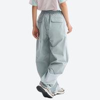 
                  
                    Lightweight water-repellent hiking pants with pockets - light blue quick-dry hiking pants with white tee, back walking view
                  
                