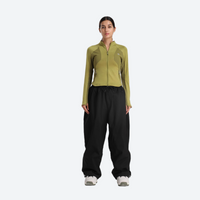 
                  
                    Women's waterproof 2L snow jacket and pants - olive green base layer top with black snow pants, on-model front view
                  
                