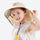 Bubble kids sun hat UPF50 with detachable neck flap - beige kids sun hat on girl, worn front view, for park days in summer
