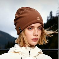 
                  
                    Fine 17.5 micron merino wool beanie - brown merino beanie on women, worn close-up view, for hiking and trail walking
                  
                