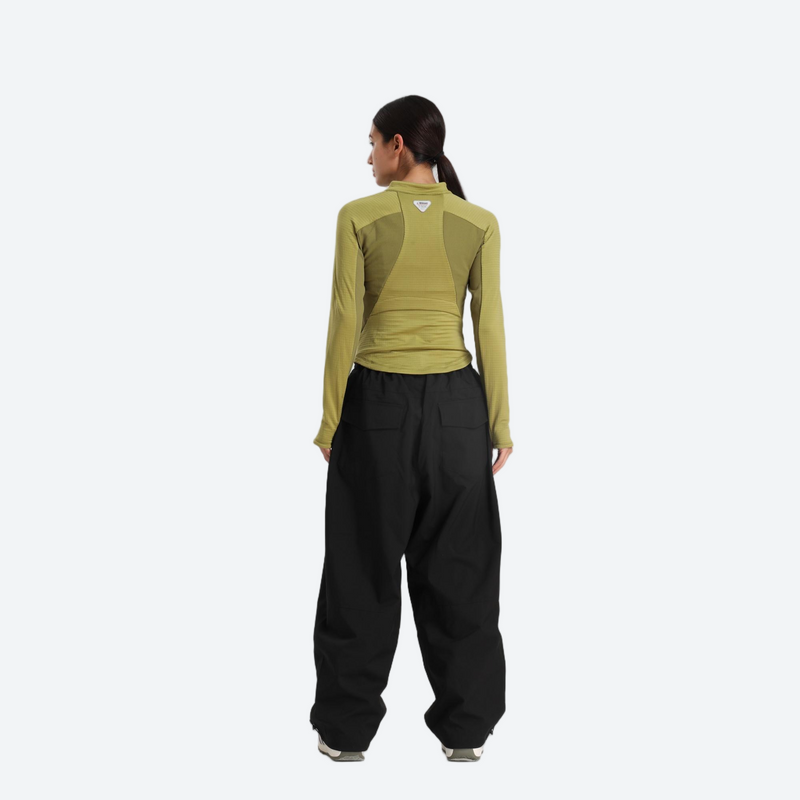 Women's waterproof 2L anorak snow jacket and pants - olive green base layer top with black snow pants, on-model back view