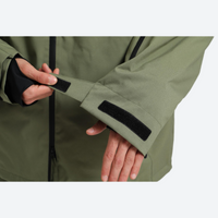 
                  
                    Men's waterproof 2L snow jacket and pants - olive green, cuff close-up with hand, for powder days and winter commute
                  
                