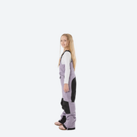 
                  
                    Kids breathable snowboard jacket and bib pants set - lavender bib pants with black knee patches, kids on-model side view
                  
                