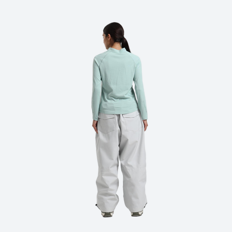Women's waterproof 2L anorak snow jacket and pants - mint green base layer top with white snow pants, on-model back view