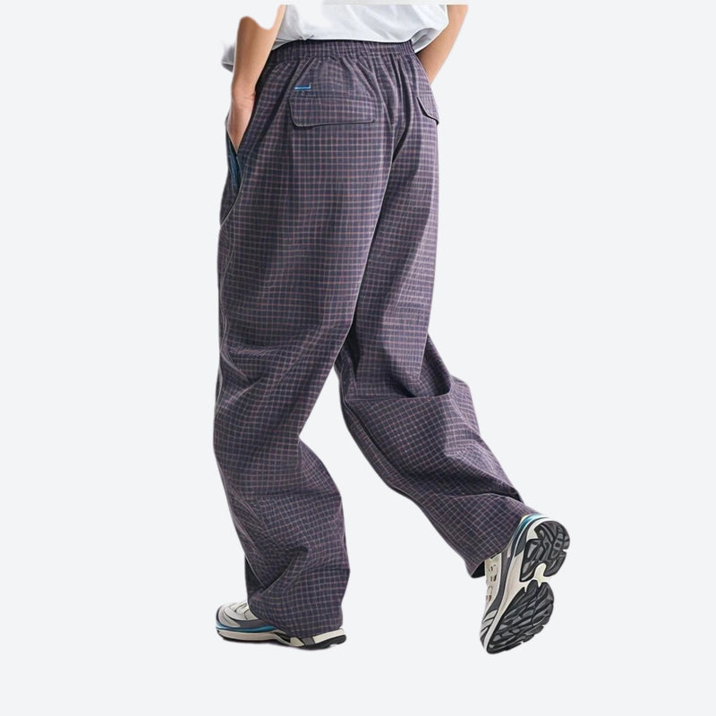 Lightweight water-repellent hiking pants with pockets - dark gray quick-dry hiking pants with blue top, back walking view