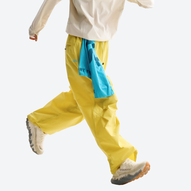 Unisex quick-dry water-repellent hiking pants - yellow wide-leg hiking pants with blue waist cloth, stride side walking view