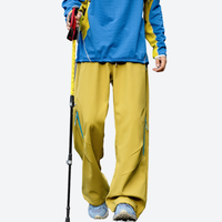 
                  
                    Water-repellent fleece hiking pants for cold days - yellow fleece-lined hiking pants with blue top
                  
                