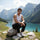 Men's slim-fit hiking pants - black slim hiking pants with white tank, sitting view on rock by lake, for city and trail wear