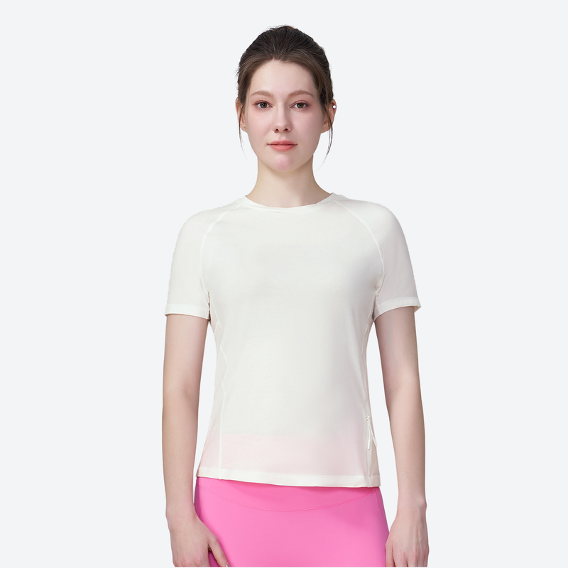Women's merino wool quick-dry tee with side pocket - cream merino wool quick-dry tee with pink shorts, front standing view