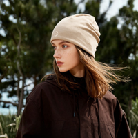 
                  
                    Soft merino wool knit hat for cold weather - beige merino beanie on women, worn side view, for skiing and snowboarding
                  
                