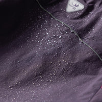
                  
                    Unisex lightweight outdoor cargo pants - purple, fabric waterproof close-up with water beads, for trail and mountain walks
                  
                