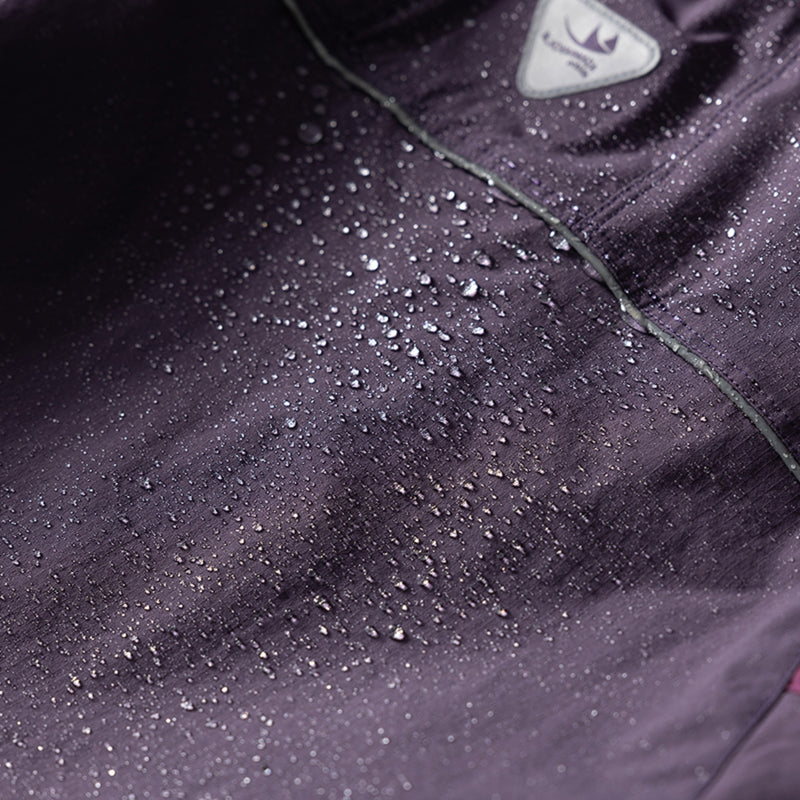 Unisex lightweight outdoor cargo pants - purple, fabric waterproof close-up with water beads, for trail and mountain walks