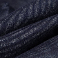 
                  
                    Unisex denim-look bib snow pants - navy denim, fabric texture close-up detail, for cold-weather winter sports
                  
                