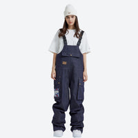 
                  
                    Breathable waterproof jean-style suspender ski pants - navy denim bib snow pants with white tee, for resort and street wear
                  
                