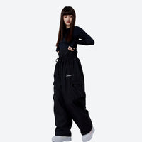 
                  
                    Unisex asymmetric snowboard jacket and cargo pants - black snow pants with black top, for cold-weather winter sports
                  
                