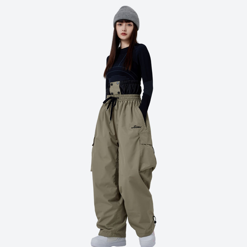 Unisex waterproof 2L asymmetric snow jacket - tan snow pants with black top, for powder days and winter commute
