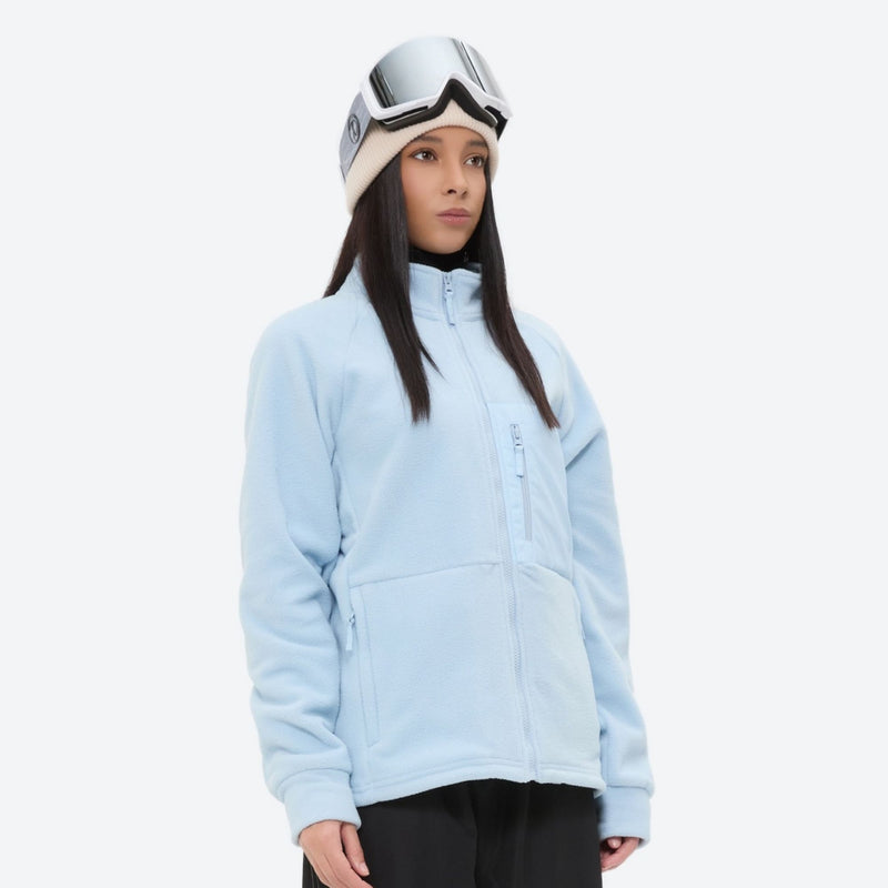 Breathable quick-dry fleece liner for layering - light blue fleece liner jacket on women with goggles, front standing view