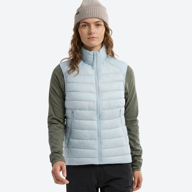Lightweight down jacket and vest collection - light blue down vest on women with beanie, for camping and outdoor weekends