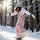 Unisex snowboard bib pants - pink bib pants with black top, riding snowboard on snowy slope, for cold-weather winter sports