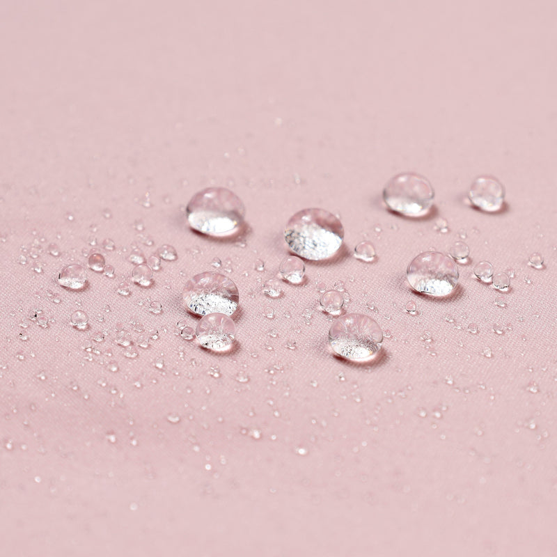 Women's waterproof one-piece snow suit - pink, fabric waterproof close-up with water beads, for skiing and snowboarding