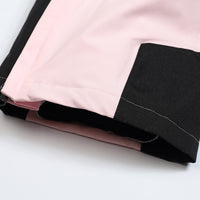 
                  
                    Women's one-piece snowboard suit with waist belt - pink, hem colorblock close-up detail, for cold-weather winter sports
                  
                