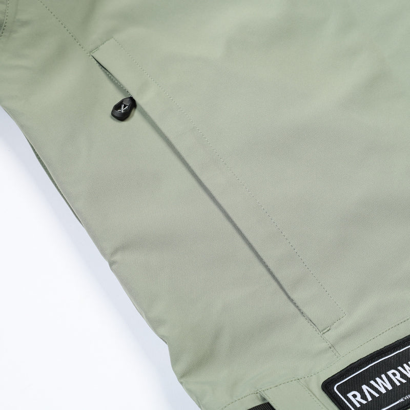 Unisex waterproof one-piece snow suit - sage green one-piece suit, pocket snap close-up detail, for skiing and snowboarding