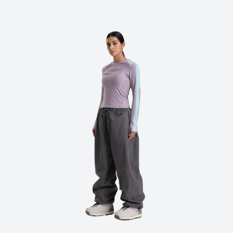 Women's waterproof 2L anorak snow jacket and pants - lavender base layer top with gray snow pants, on-model side view
