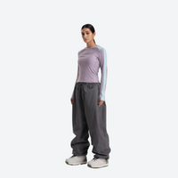 
                  
                    Women's 2-layer snowboard jacket and pants - lavender base layer top with light gray snow pants
                  
                