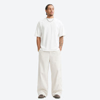
                  
                    Breathable ripstop trail pants and shorts collection - off-white wide-leg pants with white tee, for warm-weather trekking
                  
                