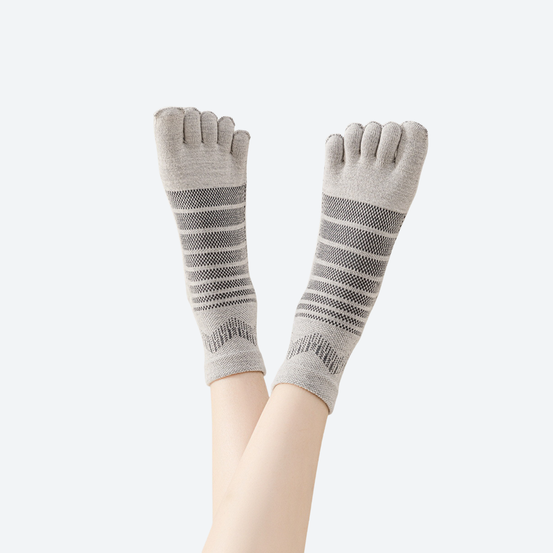 Soft stretchy merino wool toe socks - gray five-toe merino wool socks on feet, foot raised view, for hiking and trail walking