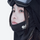 Breathable winter facemask worn with goggles - black facemask on women in black cap, worn close-up view, for resort ski days
