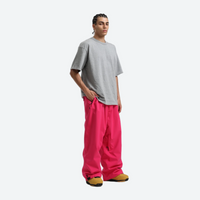 
                  
                    Men's waterproof 2L snow jacket and pants - pink snow pants with gray tee, on-model front view, for resort and street wear
                  
                