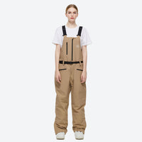 
                  
                    Unisex colorblock snowboard jacket and bibs - tan bib pants, on-model front view, for resort and backcountry days
                  
                