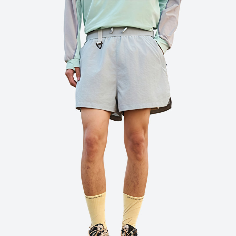 Lightweight water-repellent running shorts with liner - light blue water-repellent shorts with mint top, front standing view