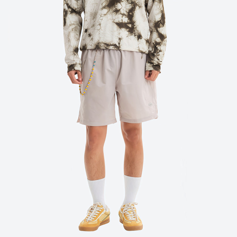 Water-repellent running shorts with drawcord waist - light gray running shorts with tie-dye top, front standing view