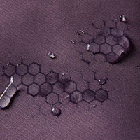 
                  
                    Unisex lightweight softshell outdoor pants - purple, fabric waterproof close-up with water beads, for skiing and snowboarding
                  
                