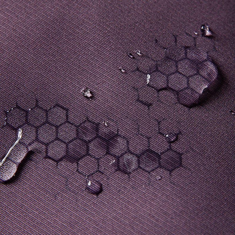 Unisex lightweight softshell outdoor pants - purple, fabric waterproof close-up with water beads, for skiing and snowboarding