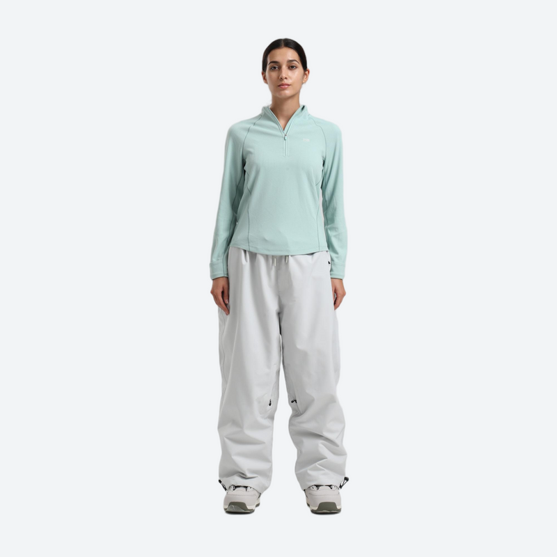 Women's waterproof 2L snow jacket and pants - mint base layer top with white snow pants, for powder days and winter commute
