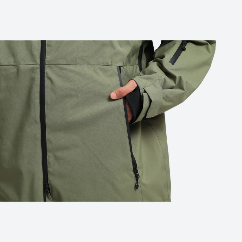 Men's breathable ski jacket with wide-leg pants - olive green, side pocket close-up with hand, for skiing and snowboarding