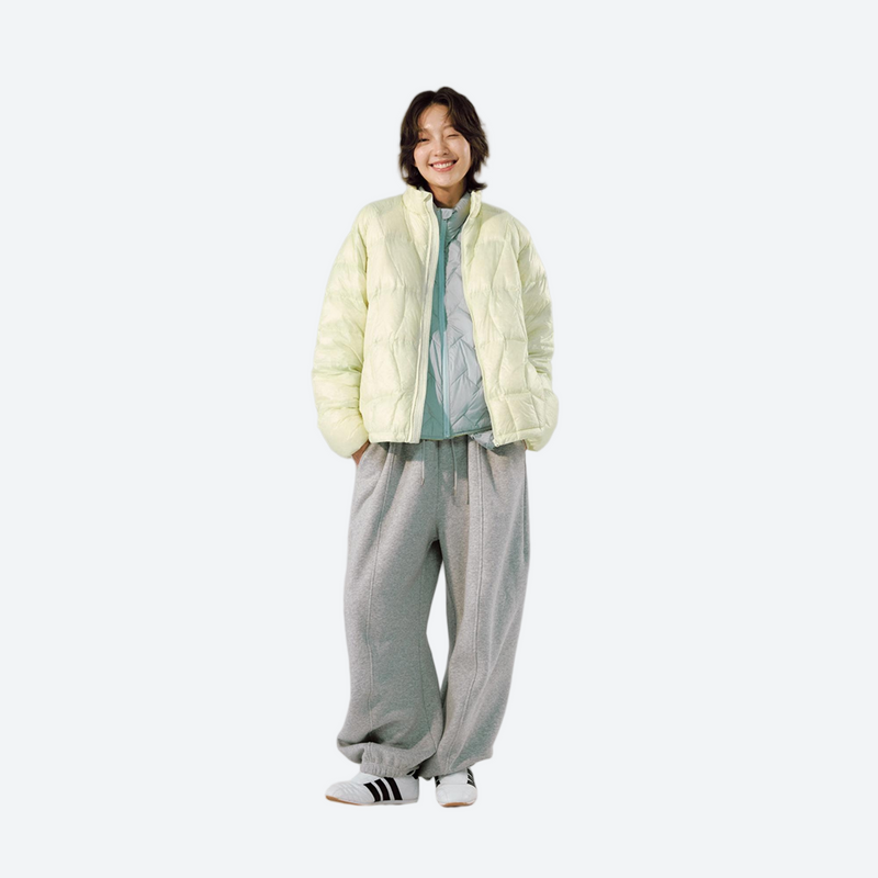 Unisex ultralight packable down vest and jacket - cream yellow ultralight down jacket on women, front standing view