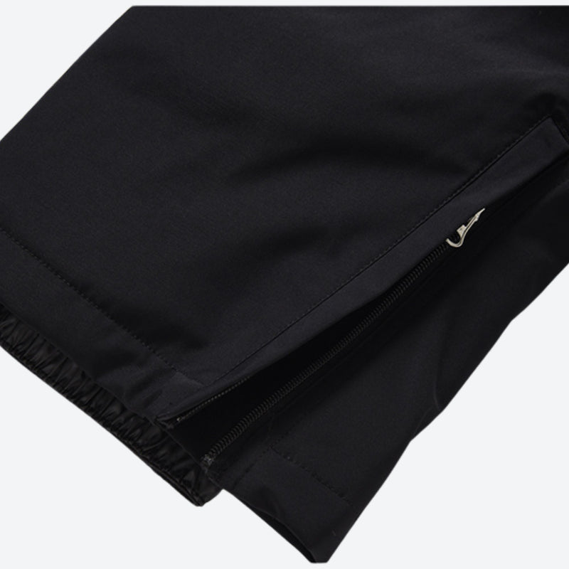 Unisex 2-layer snowboard jacket and pants - black snow pants, hem zip vent close-up detail, for skiing and snowboarding